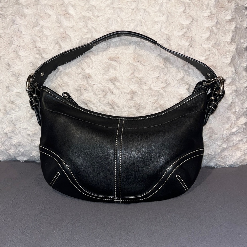 Pretty black leather Coach satchel zipper closure and adjustable strap.